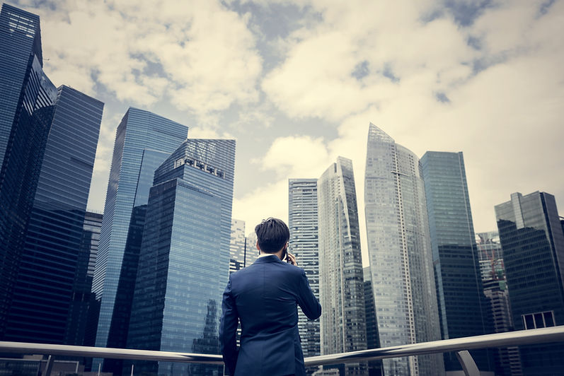 Businessman listening to the phone while looking at the skyscrapers