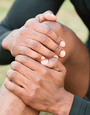 Man holding his injured knee