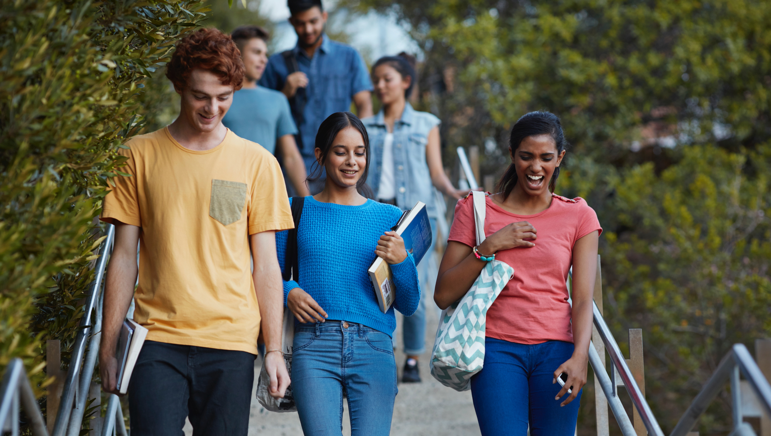 A group of high school students excitedly discussing their future plans with a college counselor, highlighting our personaliz