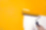 painting a wall orange with a roller