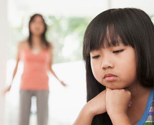 Girl sitting with chin in hands