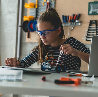 Middle Scool Student follows lesson instructions to build a robot.