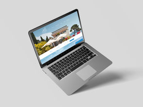 Open laptop displaying a website of a house with umbrellas and trees. Gray background, sleek design, offering a calm, inviting mood.