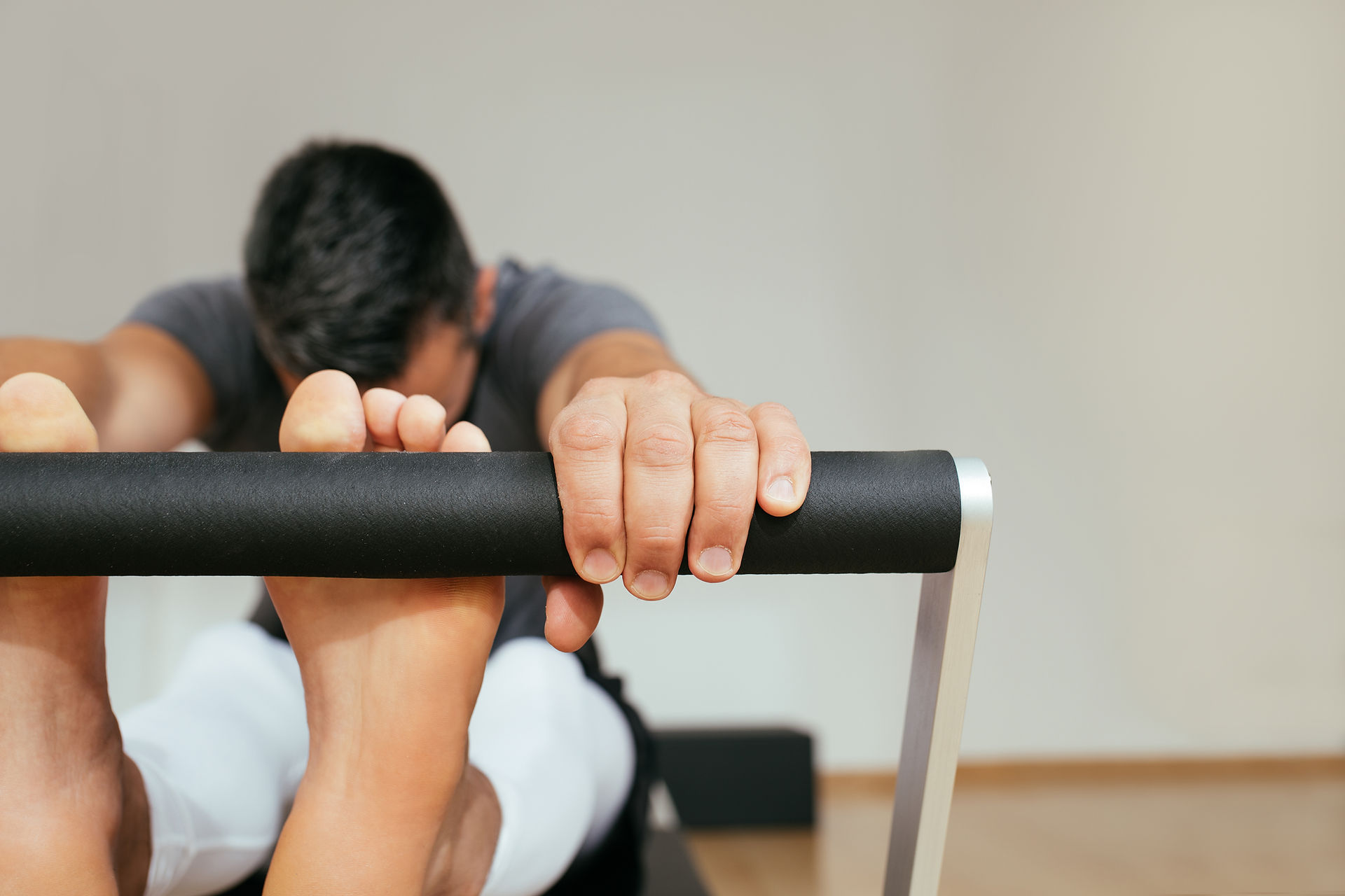 Detalle de ejercicio de estiramiento controlado en Reformer para aliviar la lumbar en Pilates Donostia
