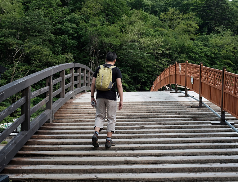 Man Walking on a Bridge