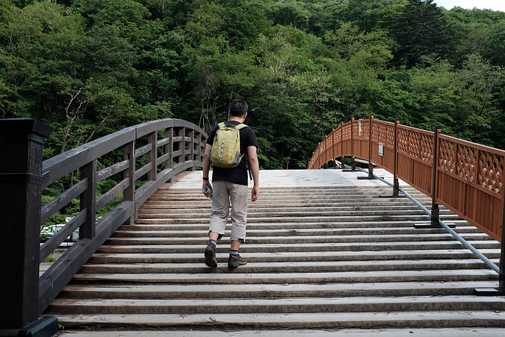 Man Walking on a Bridge