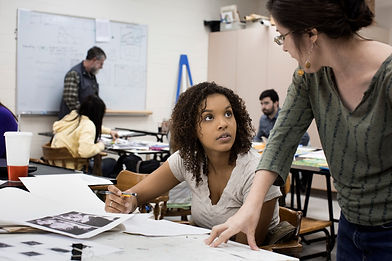 Teacher talking to student in art class