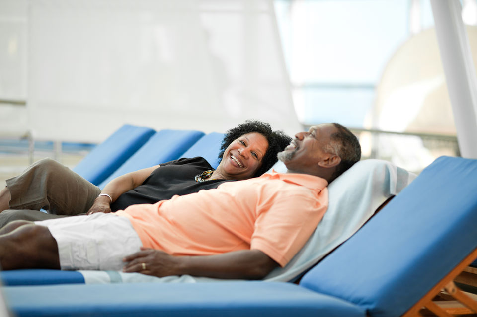 Couple relaxing on lounge chairs
