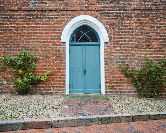 A blue front door on a brick wall