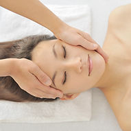 Woman client receiving facial massage from Physical Therapist