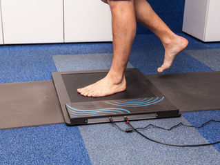 Person stepping on a body scan scale to measure fat and lean muscle mass. DEXA scan vs body scan accuracy comparison for body fat measurement. Tracking fitness progress with body scans and nutrition guidance.