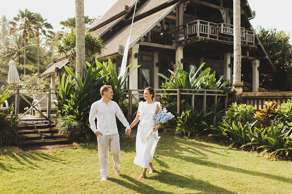 Couple walking hand in hand through a tropical villa garden during a couples retreat in Costa Rica