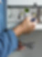 Close up of hands adjusting the dial on a boiler control panel