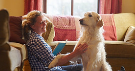 Woman sitting at home with dog