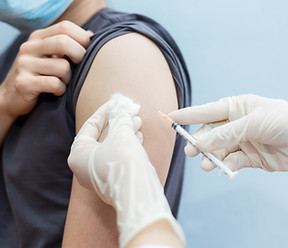 Asian man getting vaccinated