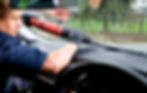 A man is repairing and replacing the glass on a car