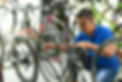 Asian man reattaching a bike chain in a bike shop