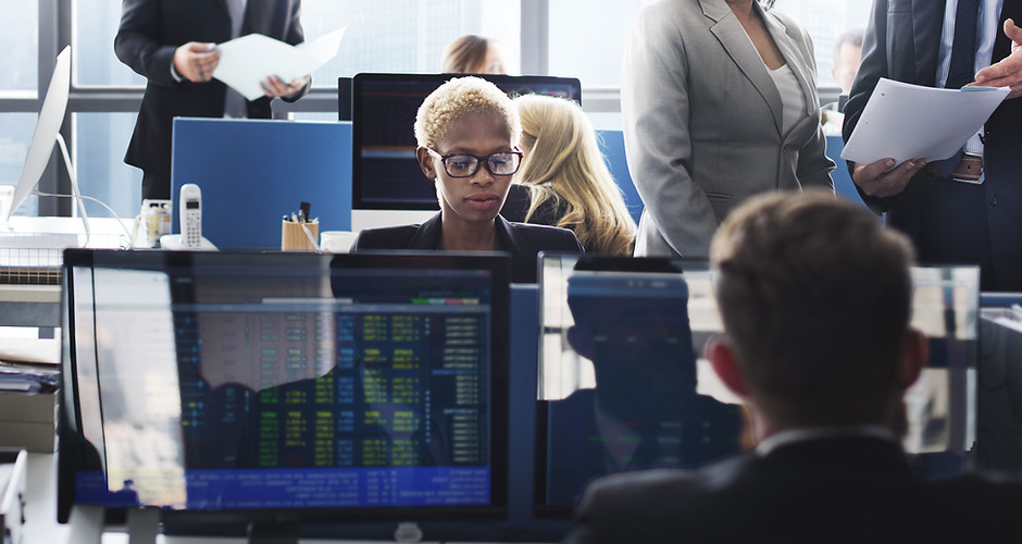 A woman sitting by her computer in a tra