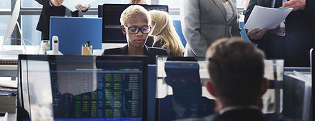 People sitting at desks in an open plan office using computers