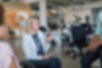 Disabled businesswoman discussing with colleagues in office