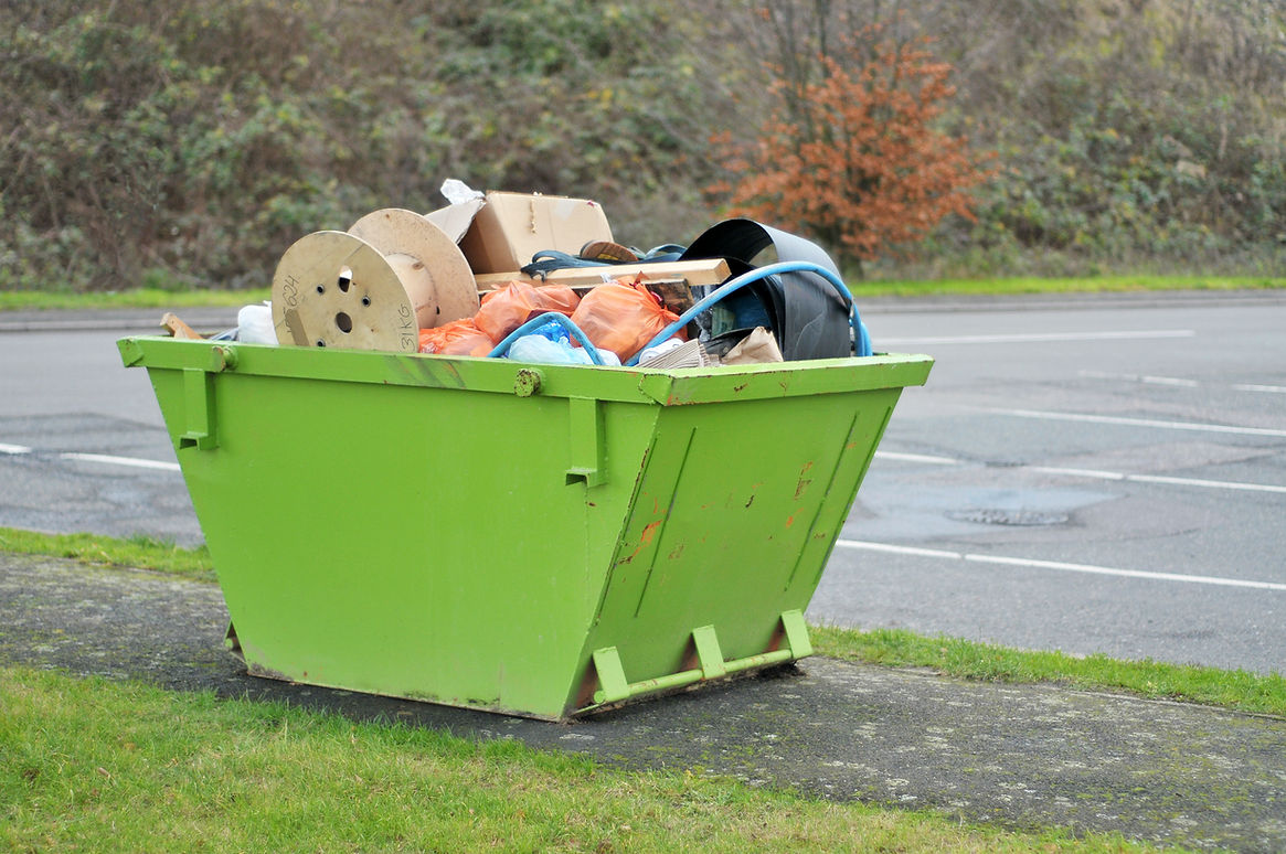 Green Skip Full Of Rubbish