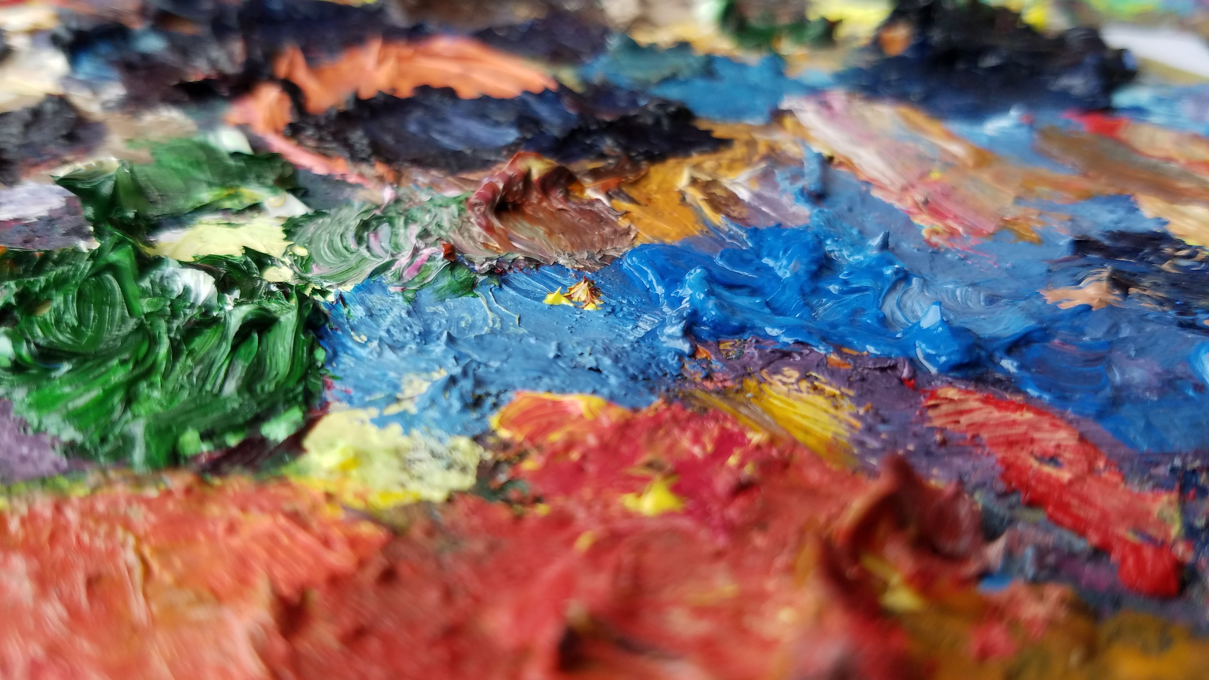 Colorful oil paint textures on an artist's palette