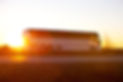 Bus on the highway at sunrise