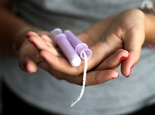Hands holding tampons