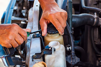 mechanic repairs a car in a garage