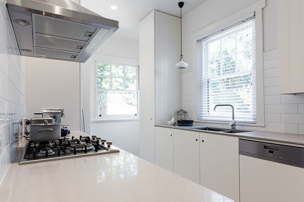 Renovated crisp white galley kitchen