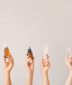 Hands holding vials up