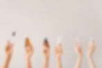 Hands holding vials up