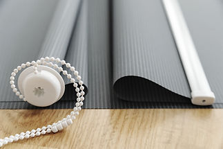 Gray fabric blinds on the wooden floor