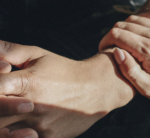 Closeup of comforting hands
