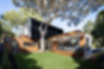Modern home with a landscaped garden and large backyard tree, representing LivFinance's support for residential development finance and tailored funding solutions for property enhancements.
