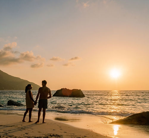 Couple walking on the beach during a romantic luxury vacation