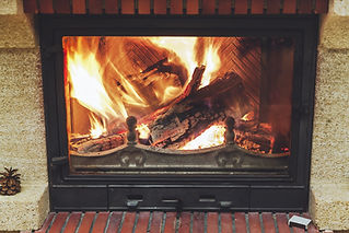Close-up of bright glowing flames inside cast iron log burner