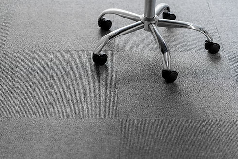 Metal swivel chair feet on grey floor