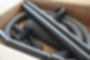 Spare parts and pipes of a new vacuum cleaner in a brown cardboard box, being unpacked