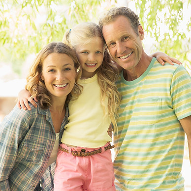 Family smiling together outdoors