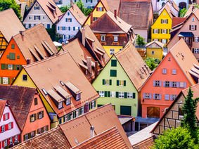 collection of brightly colored houses showing the variety of properties available for sale