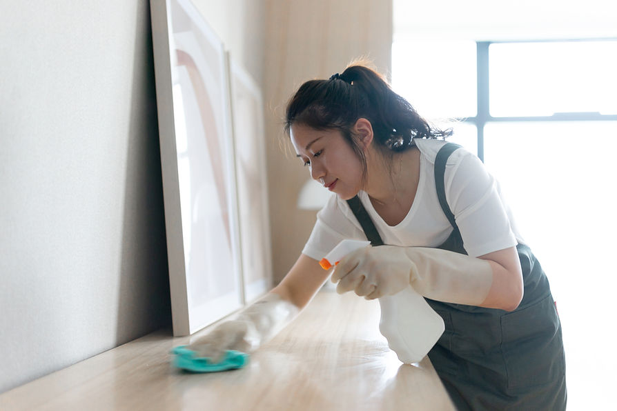 Female cleaning table at home
