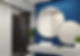 contemporary minimalist blue and white bathroom two round mirrors with black frames are on