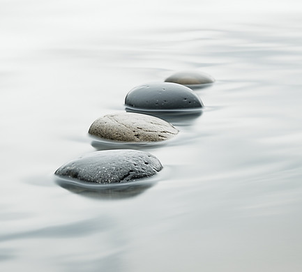 Smooth Stones sitting in Calming Waters