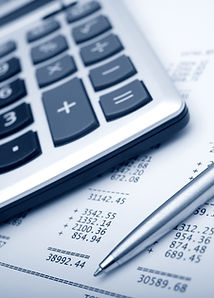 Close up of a modern calculator on a desk with financial charts