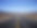 Empty straight road in the desert, heading towards distant mountains in the horizon