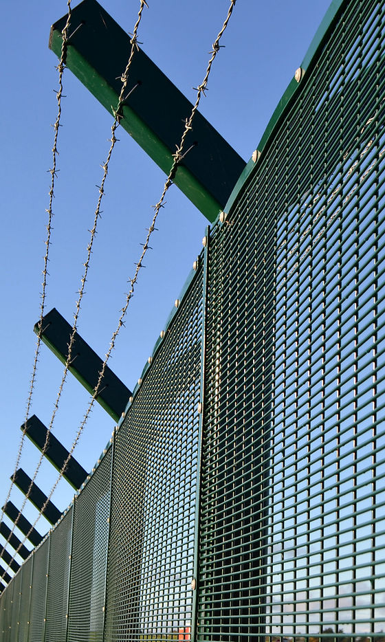 A boundary fence with barbed wire