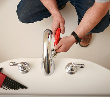 Plumber fixing a sink