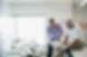 Doctor examining senior manÛªs knee in examination room