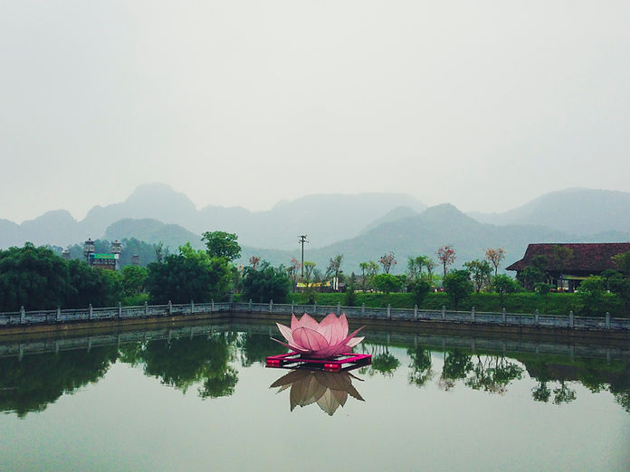 Floating illuminated lotus lantern on a lake in Vietnam